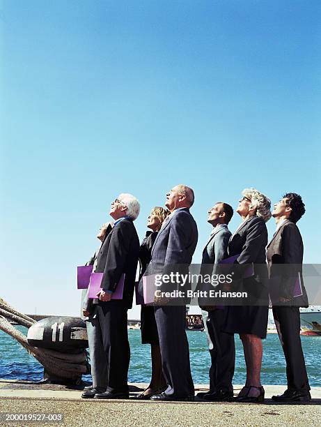 group of business people on dock looking up - japanese bussiness woman looking up stock-fotos und bilder
