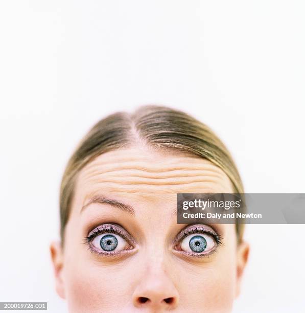 young woman, eyes wide open, portrait, high section - disbelief woman face foto e immagini stock