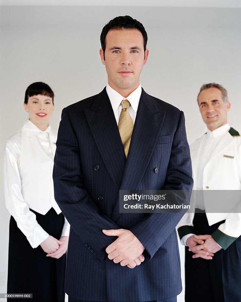 Hotel staff, manager in foreground