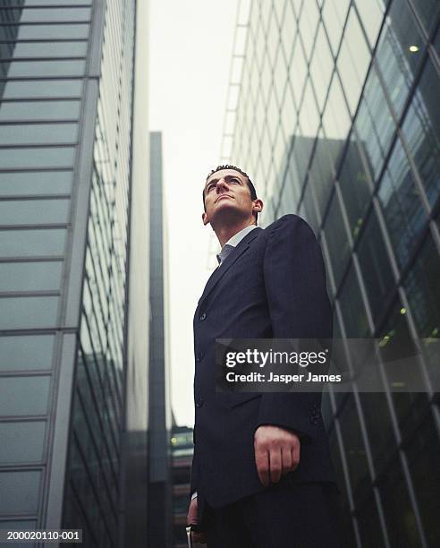 businessman in financial district, low angle view - low perspective stock pictures, royalty-free photos & images