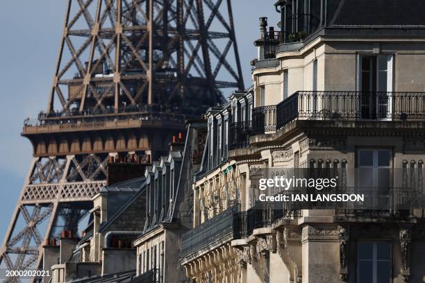 This photograph taken on February 13 shows balconies on the facade of Haussmannian buildings as the Eiffel Tower dominates the skyline , in Paris....