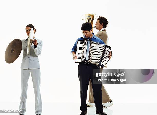 three businesspeople playing musical instruments - accordion instrument stockfoto's en -beelden