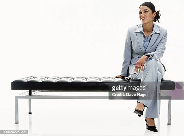 businesswoman sitting on bench - sitzen stock-fotos und bilder
