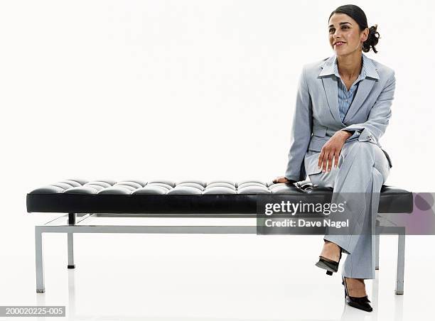 businesswoman sitting on bench - siting fotografías e imágenes de stock