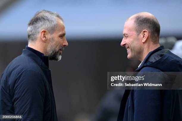 Marco Rose, Head Coach of RB Leipzig , interacts with Jess Thorup, Manager of FC Augsburg, prior to the Bundesliga match between FC Augsburg and RB...