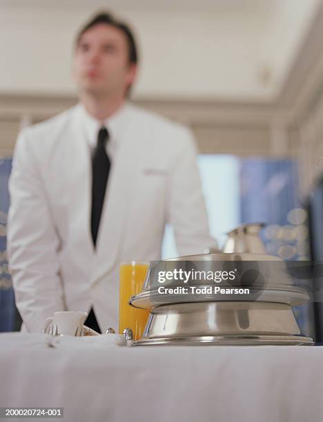 hotel waiter pushing room service cart (selective focus) - room service stock pictures, royalty-free photos & images