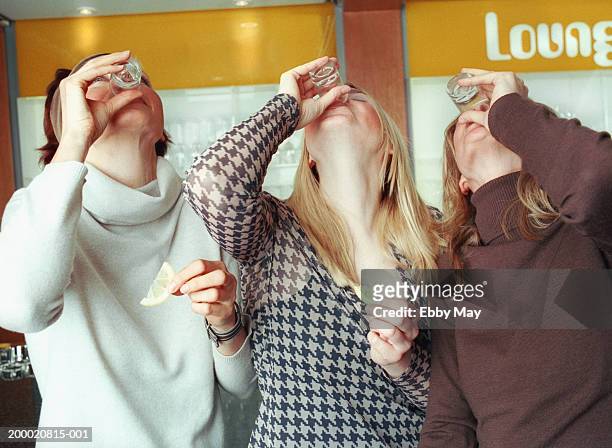 three women drinking tequila shots - tequila shot stock pictures, royalty-free photos & images