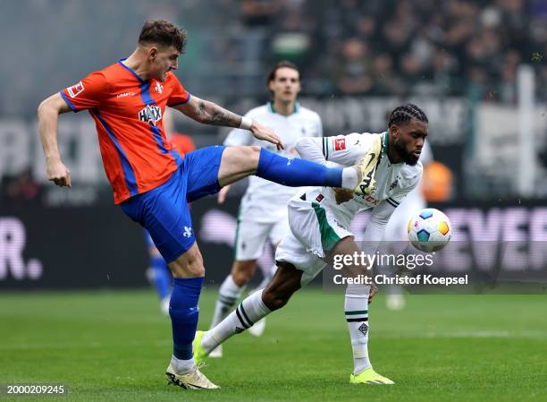 Matej Maglica of SV Darmstadt 98 controls the ball whilst under pressure from Jordan Siebatcheu of Borussia Mönchengladbach during the Bundesliga...