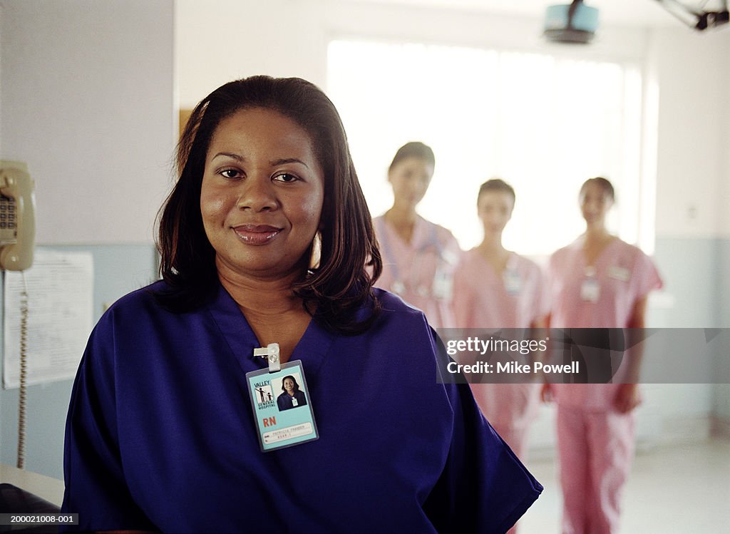 Hospital nurses, focus on nurse in blue uniform