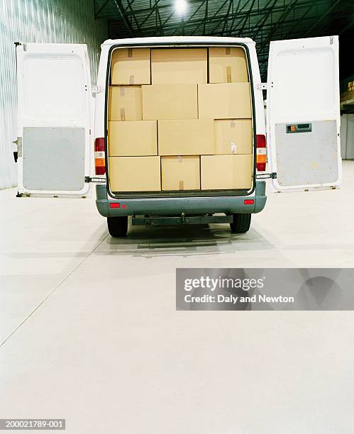 van filled with cardboard boxes in warehouse - delivery van stock pictures, royalty-free photos & images