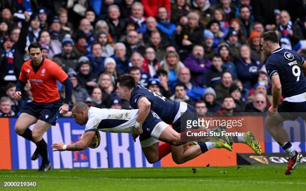 Gael Fickou of France scores his team's first try whilst under pressure from Huw Jones of Scotland during the Guinness Six Nations 2024 match between...