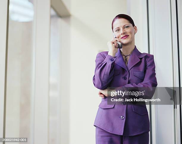 woman talking on cell phone, smiling - purple suit stock pictures, royalty-free photos & images