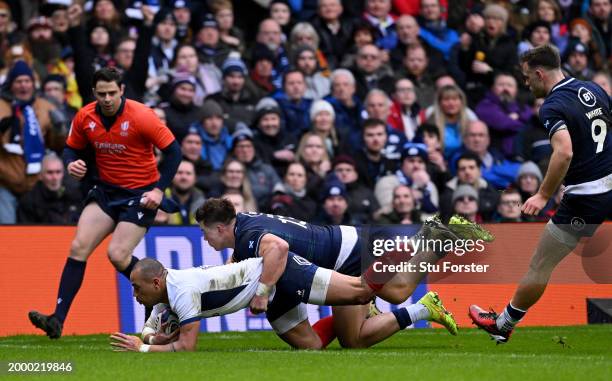 Gael Fickou of France scores his team's first try whilst under pressure from Huw Jones of Scotland during the Guinness Six Nations 2024 match between...