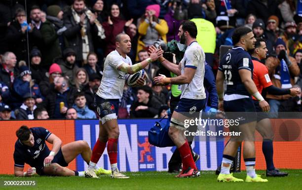 Gael Fickou of France celebrates scoring his team's first try with teammate Charles Ollivon during the Guinness Six Nations 2024 match between...