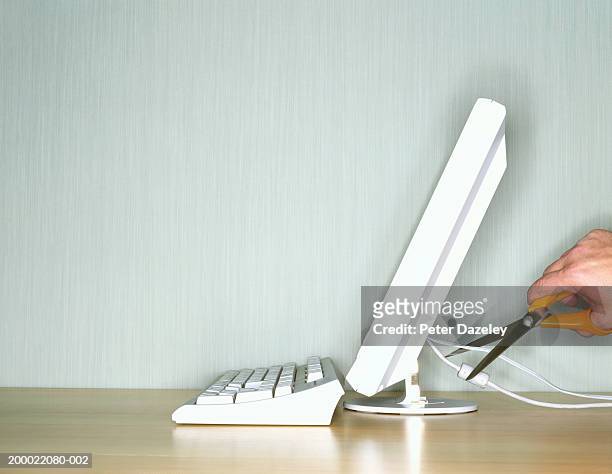 man cutting computer cable - sabotage stock pictures, royalty-free photos & images