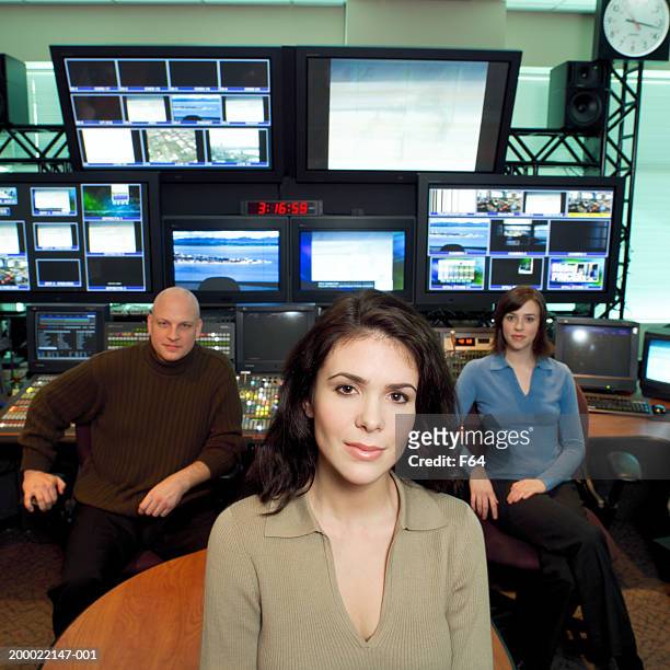 three people seated in television control room - broadcast control room stock pictures, royalty-free photos & images