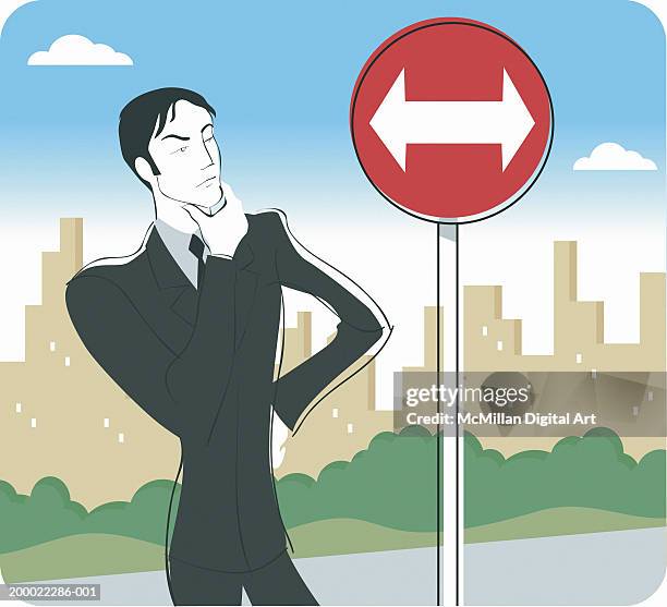 man looking at street sign with two opposing arrows - man thinking outside stock illustrations
