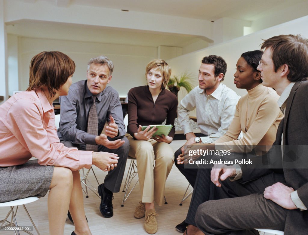 Group Of Business People Sitting In Circle Having Discussion High-Res