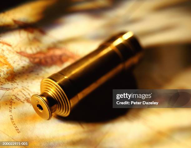 telescope on map, close-up (focus on eye piece) - day telescope stock pictures, royalty-free photos & images