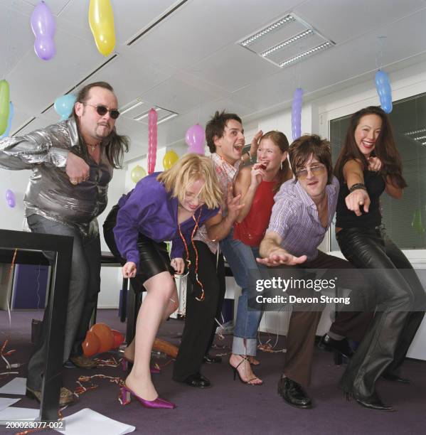 colleagues dancing at office party - office party stockfoto's en -beelden