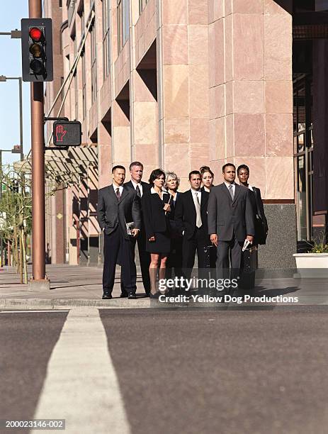 businesspeople on curb waiting to cross street - road signal imagens e fotografias de stock