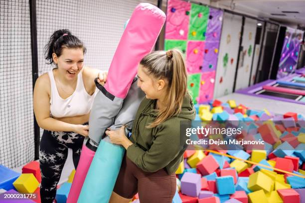 female friends having fun in indoor playground - playground balance beam stock pictures, royalty-free photos & images