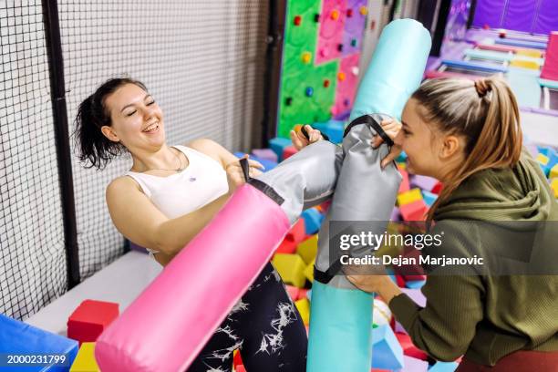 female friends having fun in indoor playground - playground balance beam stock pictures, royalty-free photos & images