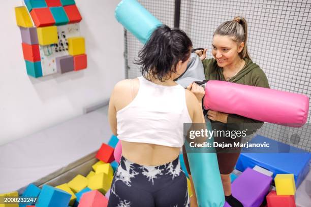 female friends having fun in indoor playground - playground balance beam stock pictures, royalty-free photos & images