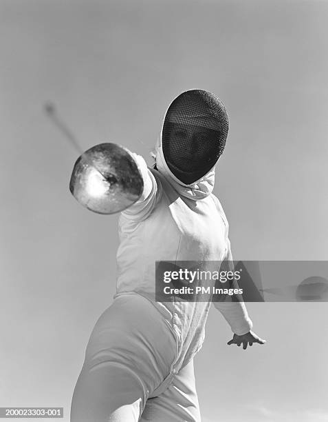 female fencer pointing sword (b&w) - mask confrontation stock pictures, royalty-free photos & images
