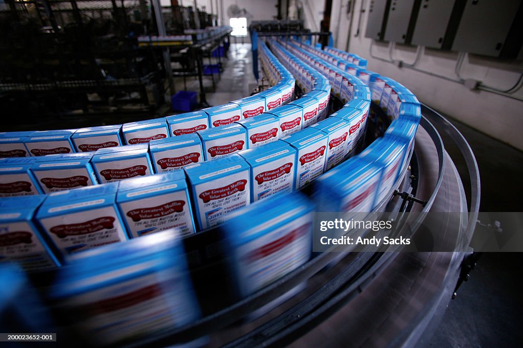 Boxes of cake mix on packing line in factory (blurred motion)