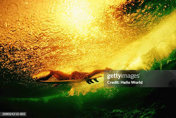 surfer lying on board, underwater view (cross processed) - cross processed stock pictures, royalty-free photos & images