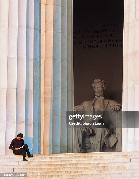 usa, washington dc, woman reading on steps of lincoln memorial - the mall stock pictures, royalty-free photos & images