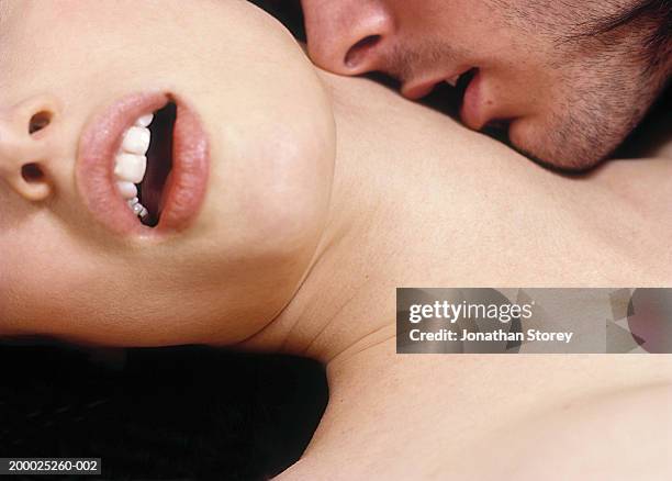 intimate couple, man kissing woman's neck, close-up - couple lust stockfoto's en -beelden