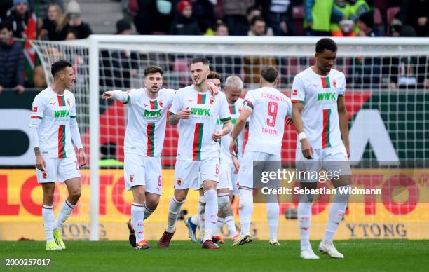 Elvis Rexhbecaj of FC Augsburg and Jeffrey Gouweleeuw of FC Augsburg celebrate after Philip Tietz of FC Augsburg scores the teams first goal during...