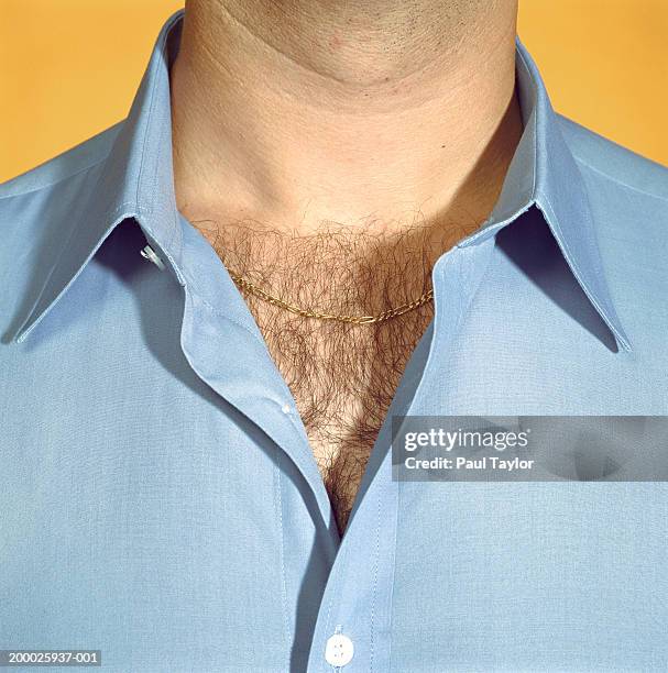 man wearing blue shirt with chest hair visible, close-up - hairy chest fotografías e imágenes de stock