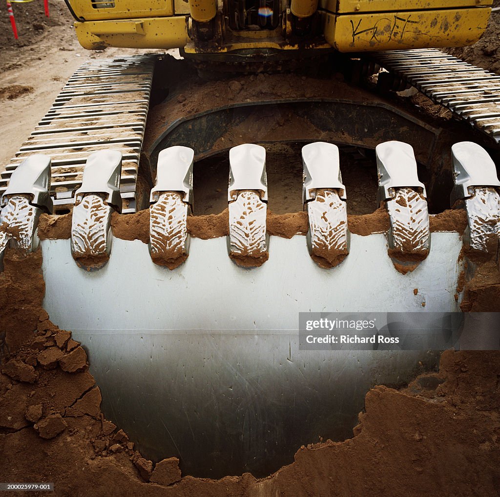 Bucket of bulldozer filled with dirt, close-up