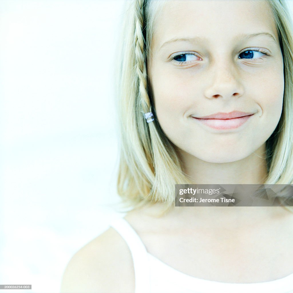 Girl (8-10) looking sideways, close-up