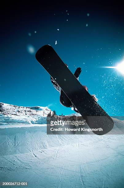 france, avoriaz, man snowboarding, mid-air jump - ハーフパイプ ストックフォトと画像