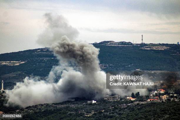 Smoke billows following Israeli bombardment in the village of Shihin in southern Lebanon near the border with Israel on February 13 amid ongoing...