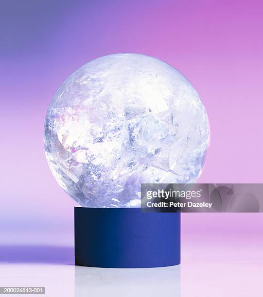 crystal ball balancing on stand, close-up - glass ball stock pictures, royalty-free photos & images