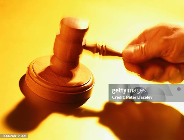 judge striking gavel, close-up (blurred motion) - gavel stock pictures, royalty-free photos & images