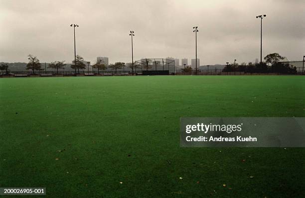 athletic field with baseball cage in background - 陸上競技場　無人 ストックフォトと画像