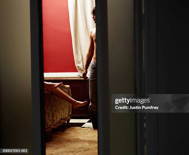 young couple in bedroom, view through open door - bedroom doorway stock pictures, royalty-free photos & images