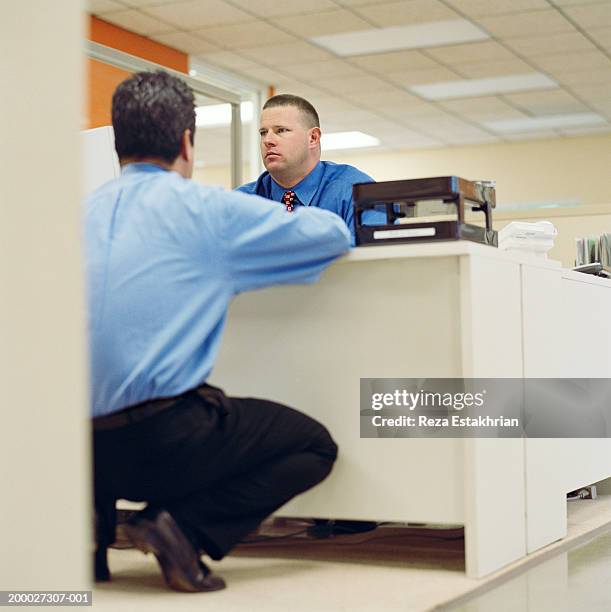 two businessmen having meeting at desk in office - blaues hemd stock-fotos und bilder