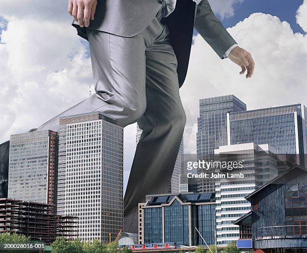 england, london, docklands, giant man passing offices, low section - 巨人 ストックフォトと画像