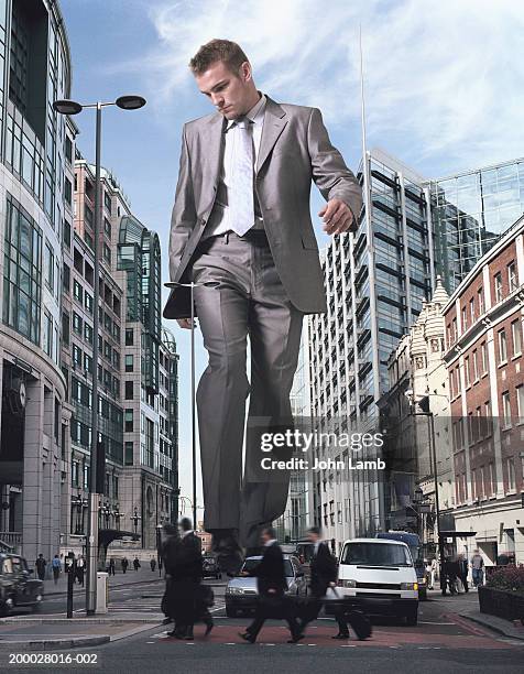 england, london, financial district, giant businessman walking street - big brother orwellian concept stock pictures, royalty-free photos & images