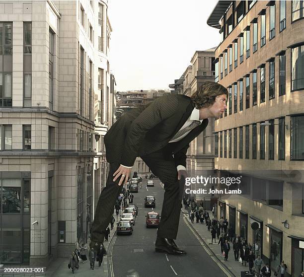 england, london, giant businessman on old broad street - giants stock-fotos und bilder