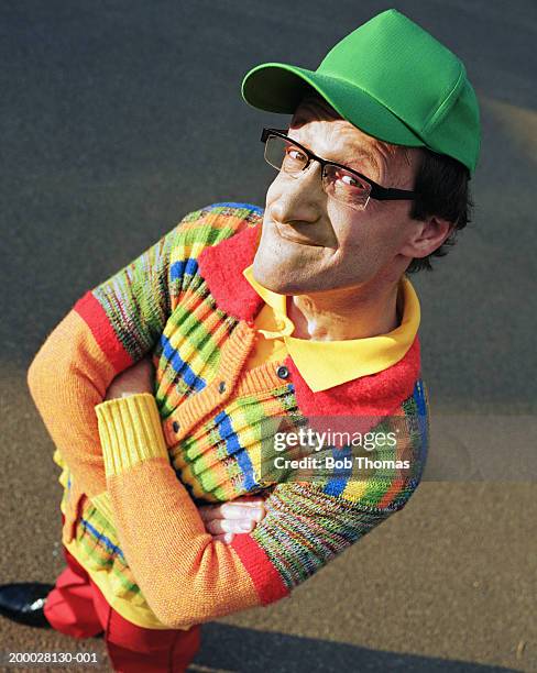 man wearing multi coloured clothing, arms folded, outdoors, portrait - trucker's hat stock pictures, royalty-free photos & images