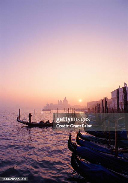 italy, venice gondolas at sunset - venice italy gondola stock pictures, royalty-free photos & images