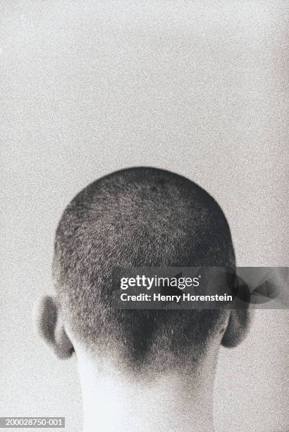 young man with shaved head, high section, rear view (grainy, b&w) - shaved head ストックフォトと画像